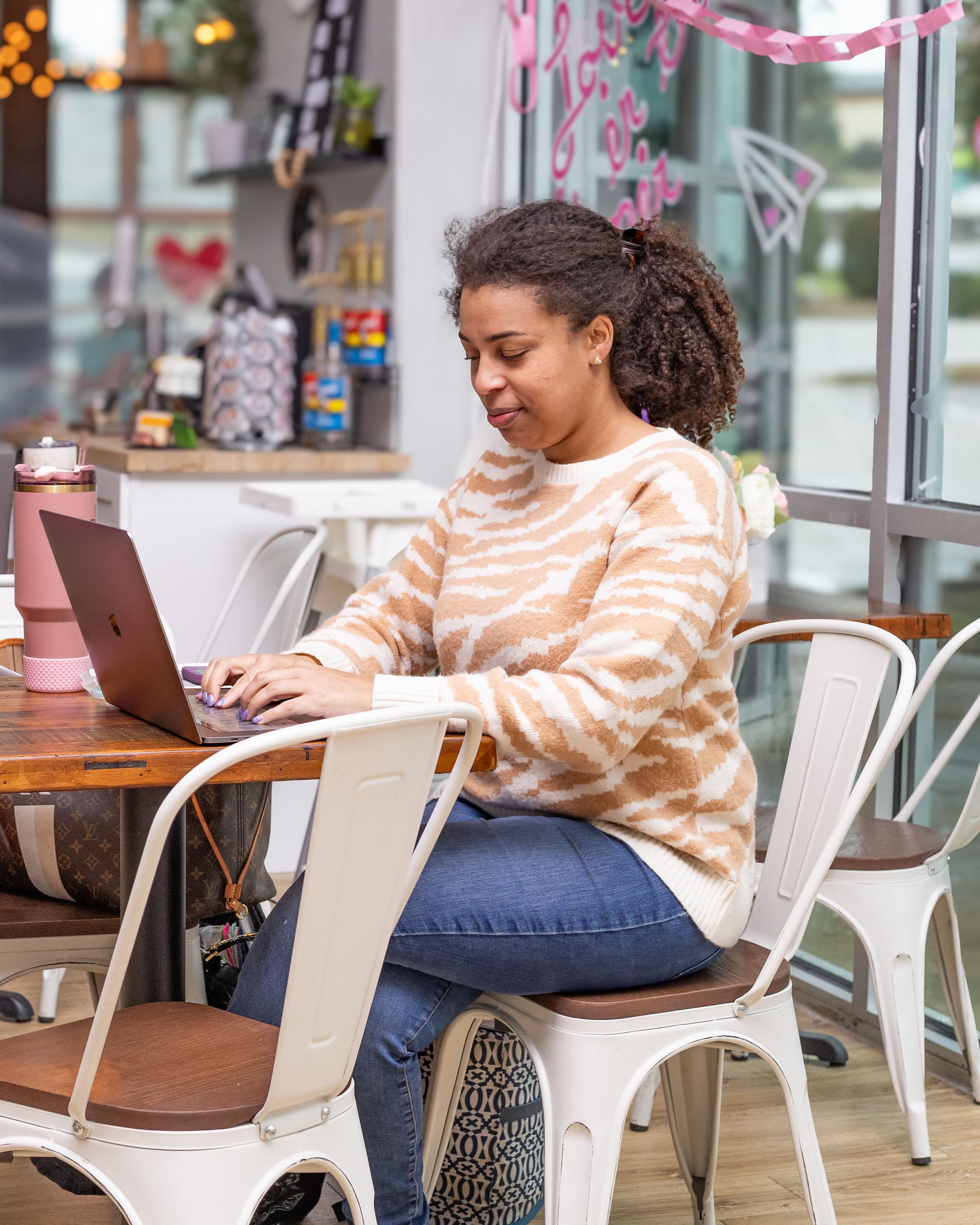Parent relaxing with a laptop in the lounge
