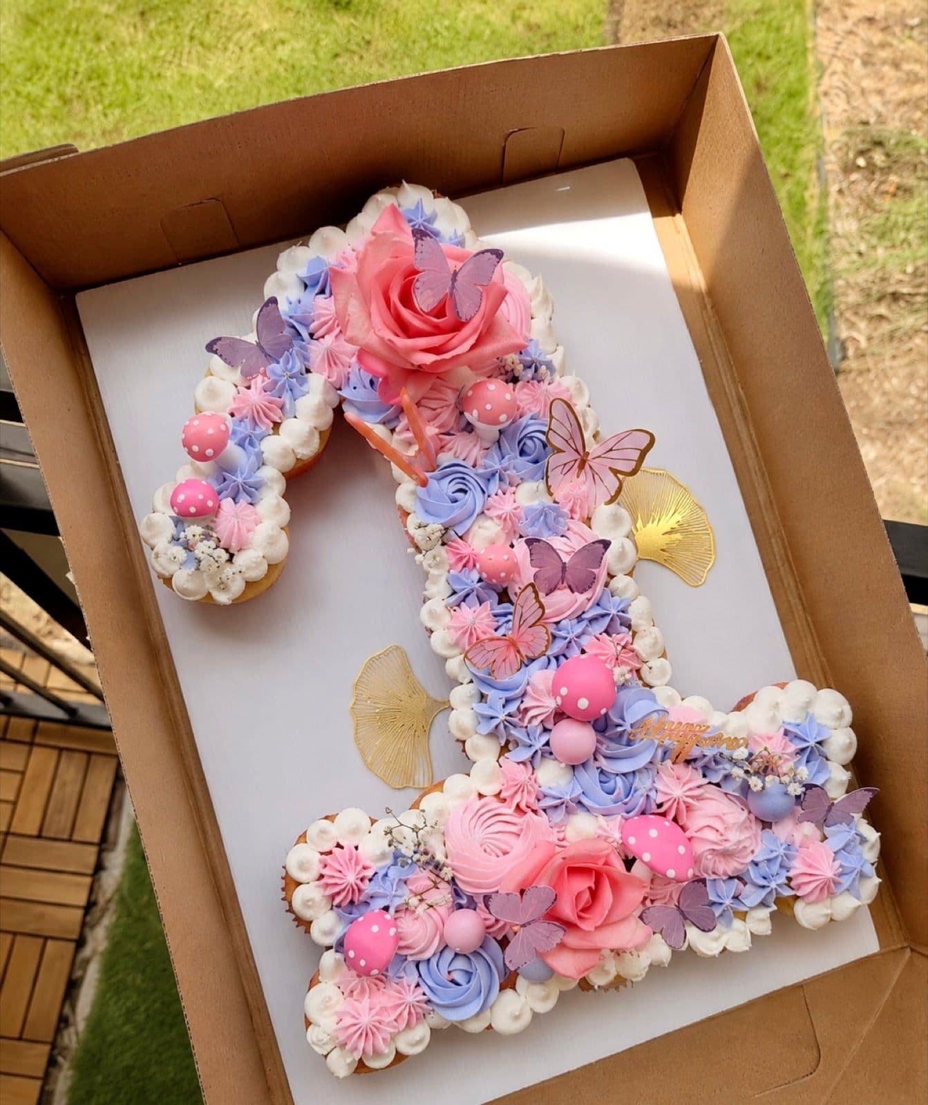A custom butterfly birthday cake with a number one topper