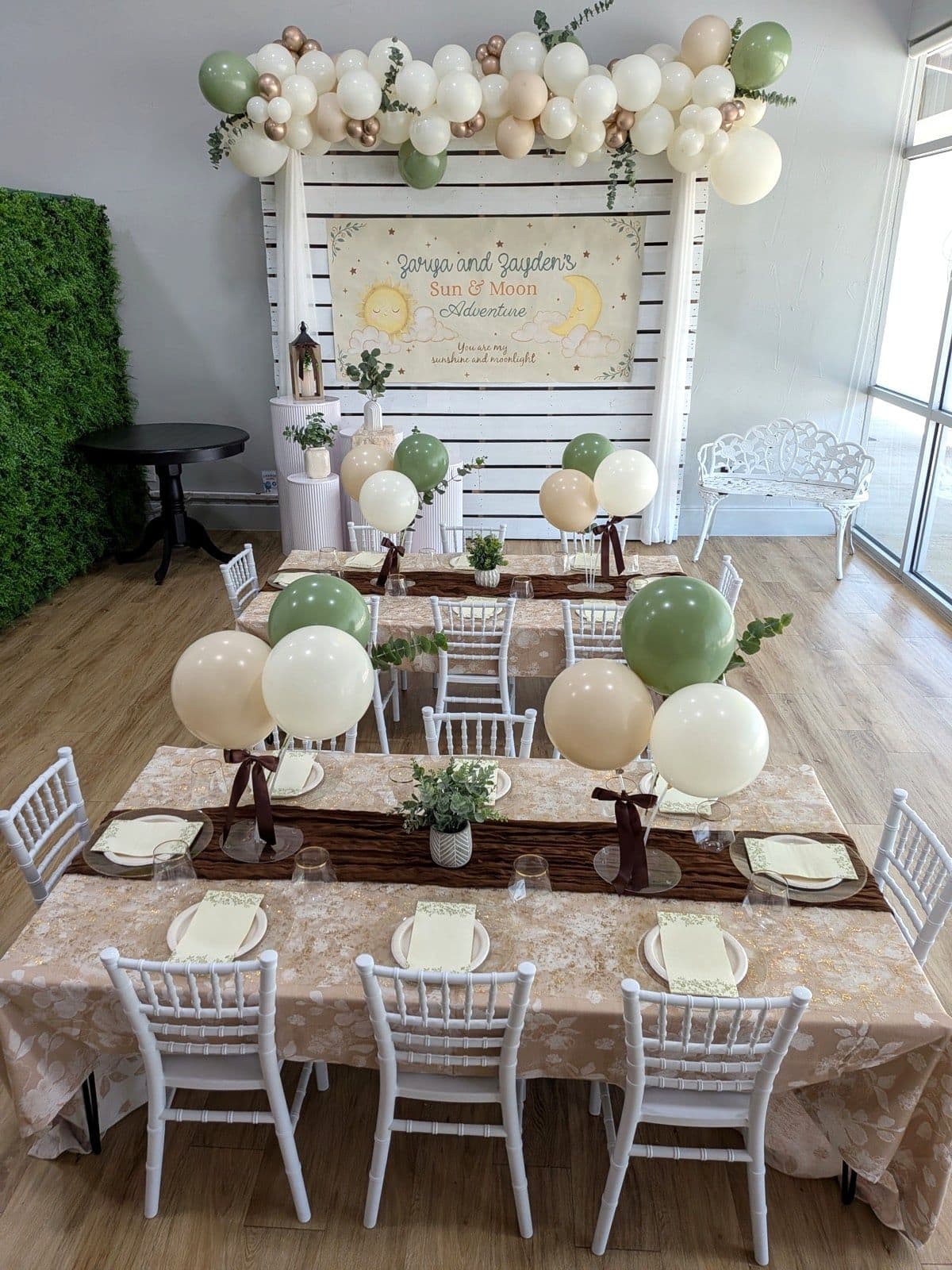 Boho sun and moon setup in sage, cream and rose gold with eucalyptus and a hand lettered banner